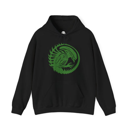 Image 4 of a Hooded Sweatshirt of a Xenomorph standing over its prey in a dimly lit chamber, its glossy exoskeleton reflecting harsh industrial lighting. Shadows stretch across the floor as its elongated skull tilts forward, ready to attack. The composition emphasizes isolation, terror, and the unstoppable instinct of a creature designed purely for survival and dominance.