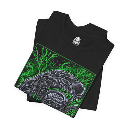 Image 5 of a T-Shirt design of a Xenomorph from Alien, emerging from deep shadows with its elongated biomechanical head glistening under dim industrial light. Acidic saliva drips from its jaws as its inner mouth prepares to strike. The design captures the creature’s perfect organism form, blending organic horror with cold alien precision in a setting filled with tension and dread.