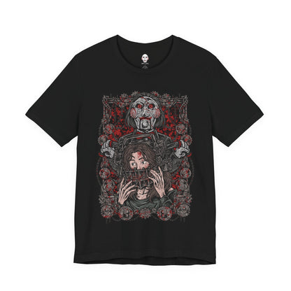 Image 4 of a T-Shirt design of Billy the Puppet from Saw, seated on his tricycle in a dimly lit room surrounded by rusted chains, flickering lights, and blood-stained walls. His pale face, spiraled red cheeks, and unblinking eyes create an unsettling presence. The design captures the psychological horror of Jigsaw’s games and the fear of being forced to choose between survival and sacrifice.