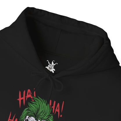 Folded Hooded Sweatshirt of the Joker and Harley Quinn seated atop a pile of stolen cash and broken carnival props beneath neon lights. Harley’s colorful outfit contrasts with the Joker’s eerie purple suit as confetti and smoke swirl through the air. The composition emphasizes comic-book chaos, psychological manipulation, and the unforgettable partnership between Gotham’s Clown Prince of Crime and his equally unpredictable accomplice.