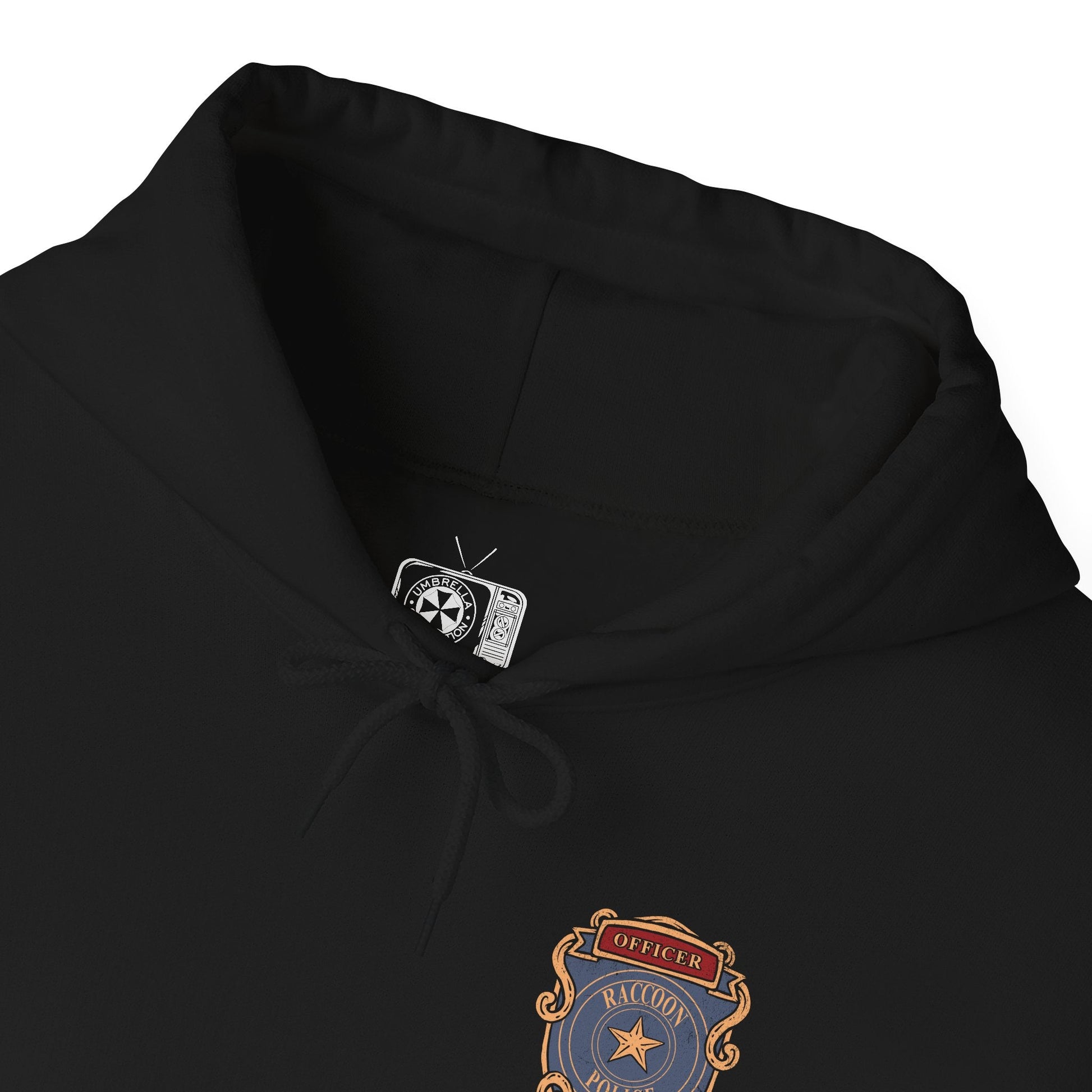 Folded Hooded Sweatshirt of Leon S. Kennedy from Resident Evil 2, an inexperienced officer facing a relentless zombie horde, standing amid the destruction of Raccoon City. With weapon raised and enemies closing in, the scene captures a classic survival horror moment fueled by tension, danger, and the will to endure.
