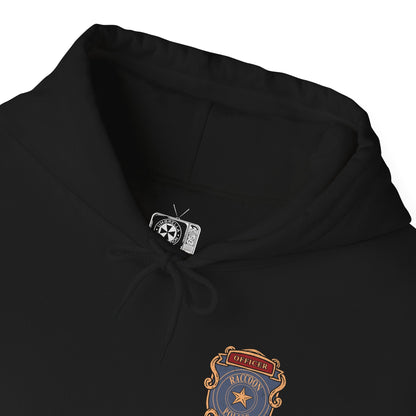 Folded Hooded Sweatshirt of Leon S. Kennedy from Resident Evil 2, an inexperienced officer facing a relentless zombie horde, standing amid the destruction of Raccoon City. With weapon raised and enemies closing in, the scene captures a classic survival horror moment fueled by tension, danger, and the will to endure.